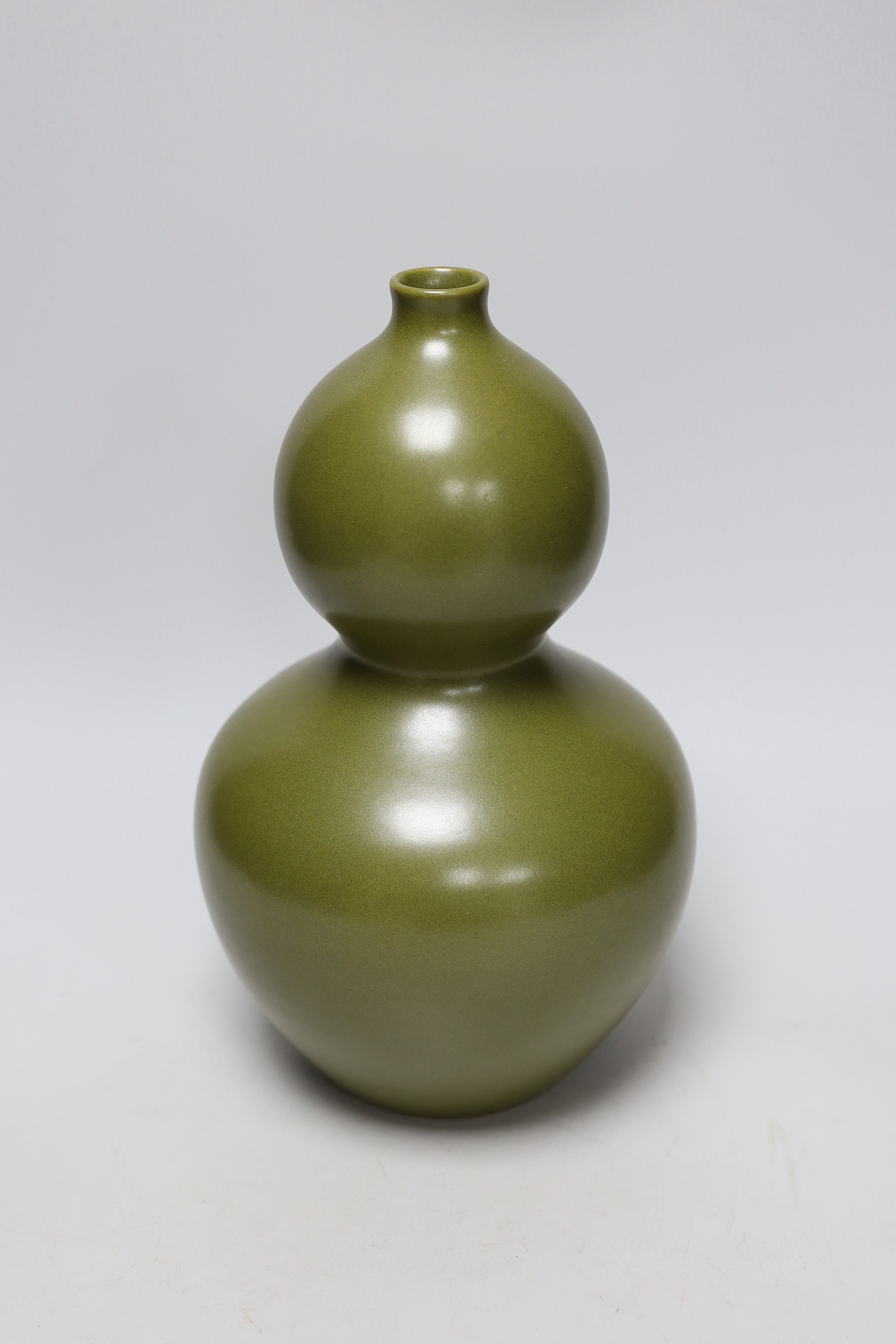 A Chinese olive green double gourd vase, 29cm high